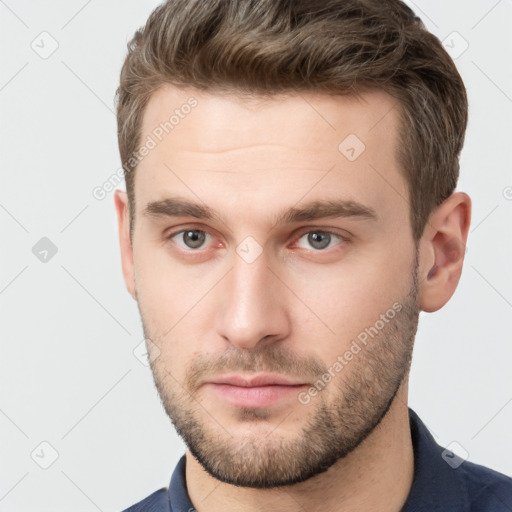 Neutral white young-adult male with short  brown hair and grey eyes