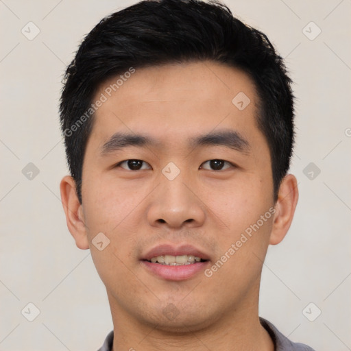 Joyful asian young-adult male with short  black hair and brown eyes