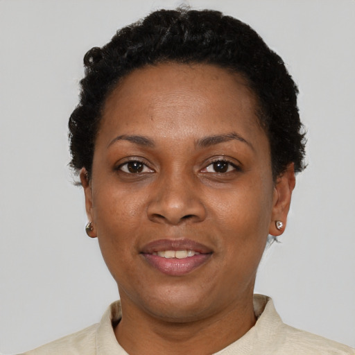 Joyful black adult female with short  black hair and brown eyes