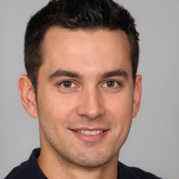 Joyful white adult male with short  brown hair and brown eyes