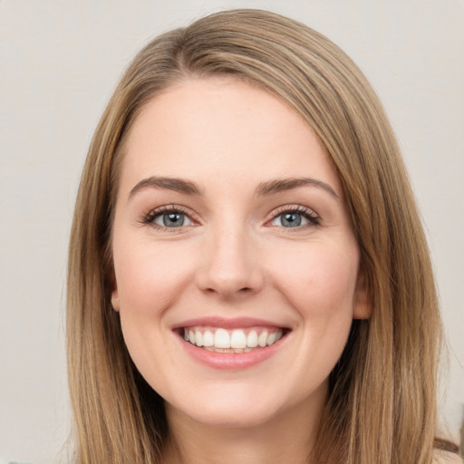 Joyful white young-adult female with long  brown hair and green eyes