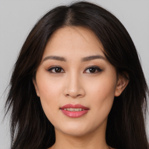 Joyful asian young-adult female with long  black hair and brown eyes