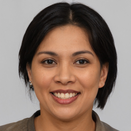 Joyful asian adult female with medium  black hair and brown eyes