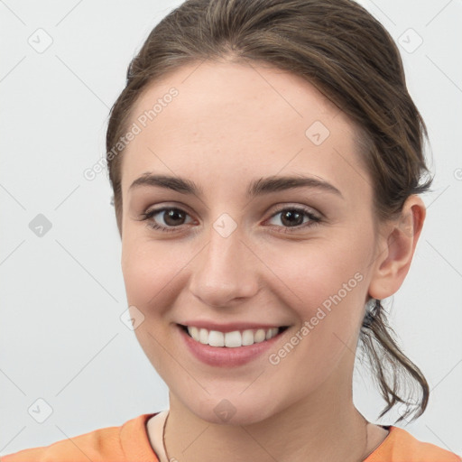 Joyful white young-adult female with medium  brown hair and grey eyes