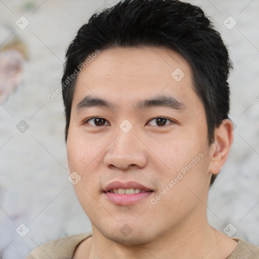 Joyful asian young-adult male with short  black hair and brown eyes