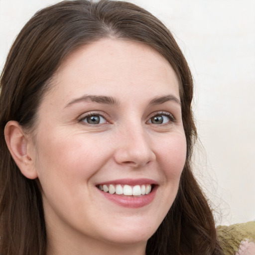 Joyful white young-adult female with long  brown hair and grey eyes