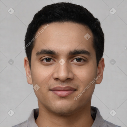 Joyful latino young-adult male with short  black hair and brown eyes