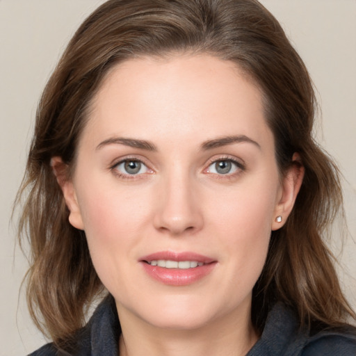 Joyful white young-adult female with medium  brown hair and grey eyes