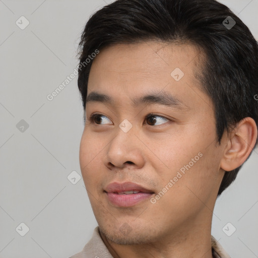 Joyful asian young-adult male with short  brown hair and brown eyes