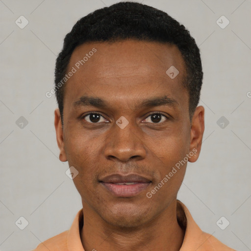 Joyful black young-adult male with short  black hair and brown eyes