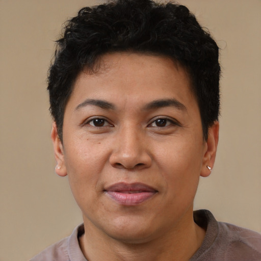 Joyful latino adult male with short  brown hair and brown eyes