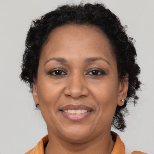 Joyful black adult female with short  brown hair and brown eyes