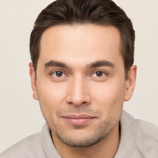 Joyful white young-adult male with short  brown hair and brown eyes