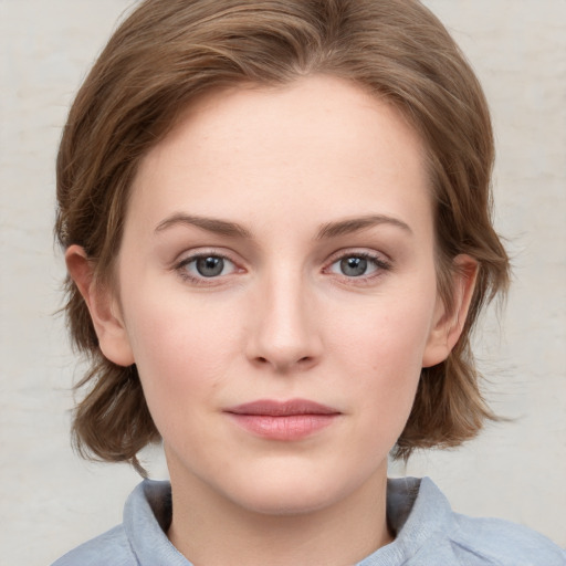 Joyful white young-adult female with medium  brown hair and blue eyes