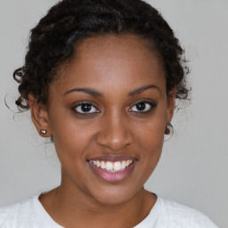 Joyful black young-adult female with short  brown hair and brown eyes