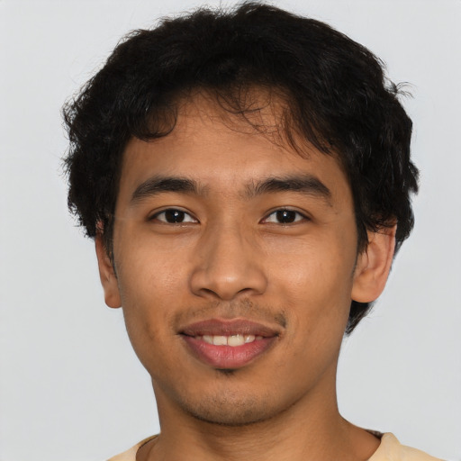 Joyful latino young-adult male with short  brown hair and brown eyes