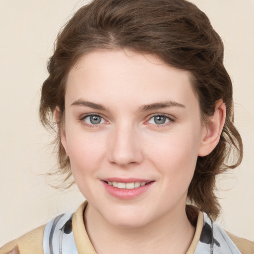 Joyful white young-adult female with medium  brown hair and blue eyes