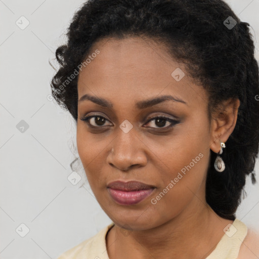 Joyful black young-adult female with long  brown hair and brown eyes