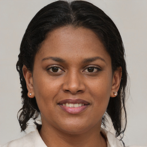Joyful black young-adult female with medium  brown hair and brown eyes