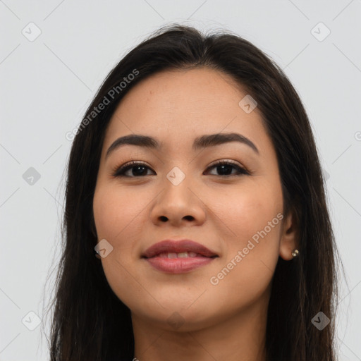 Joyful latino young-adult female with long  brown hair and brown eyes