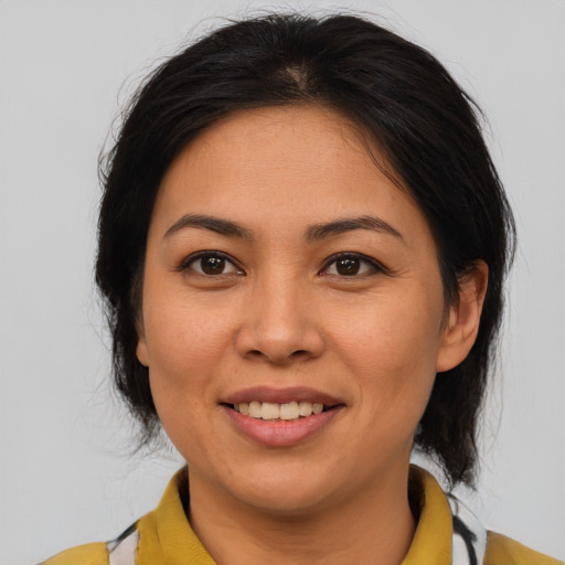 Joyful asian young-adult female with medium  brown hair and brown eyes