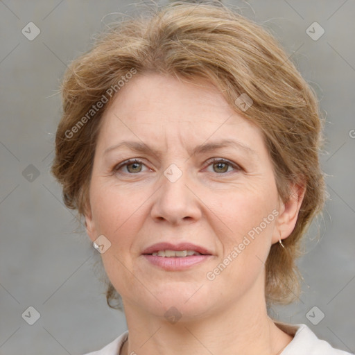 Joyful white adult female with medium  brown hair and grey eyes