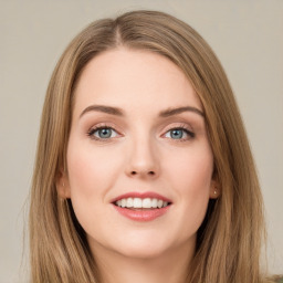 Joyful white young-adult female with long  brown hair and green eyes