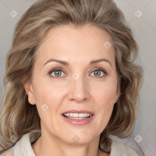 Joyful white adult female with medium  brown hair and blue eyes