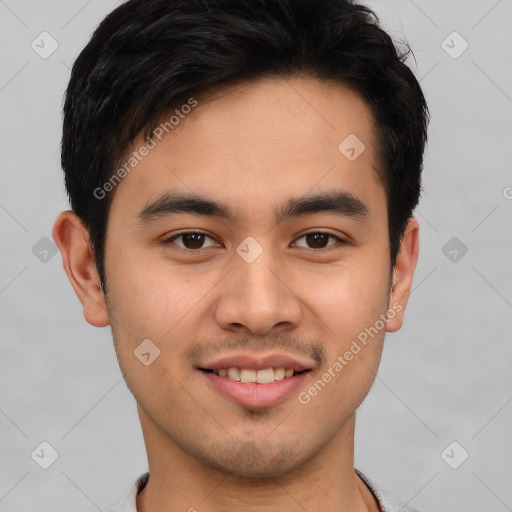 Joyful latino young-adult male with short  brown hair and brown eyes