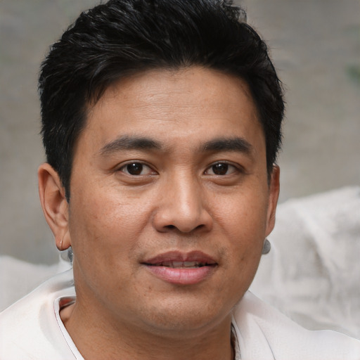 Joyful asian young-adult male with short  brown hair and brown eyes