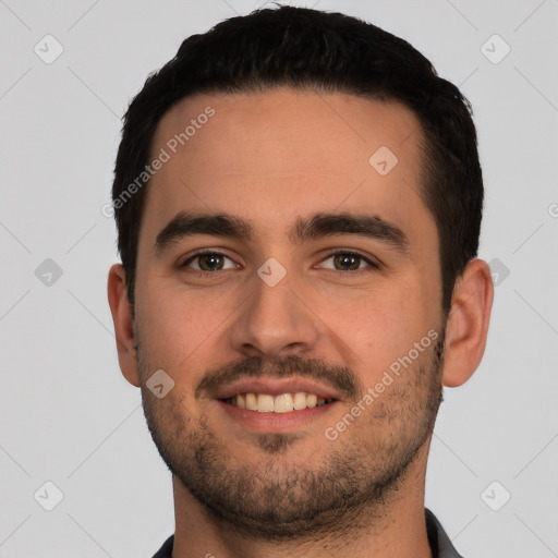 Joyful white young-adult male with short  black hair and brown eyes