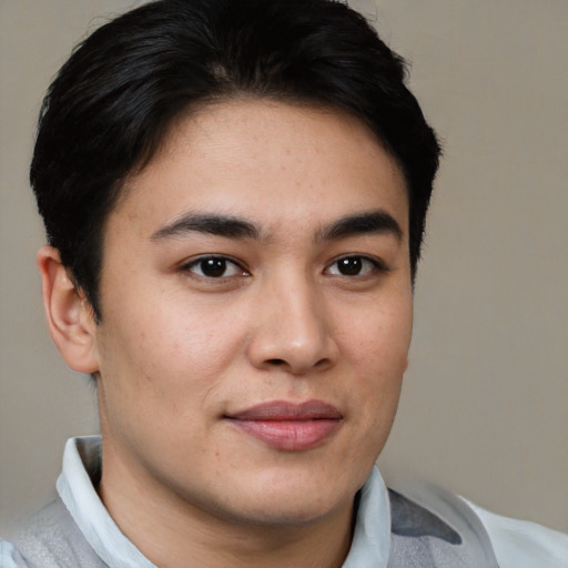 Joyful asian young-adult male with short  brown hair and brown eyes