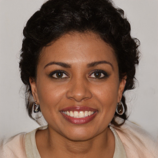 Joyful black young-adult female with medium  brown hair and brown eyes