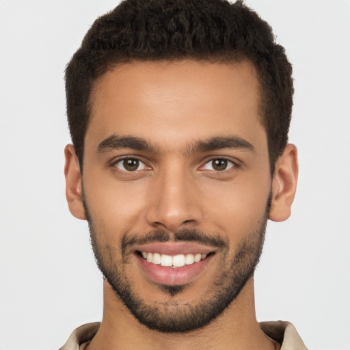 Joyful latino young-adult male with short  brown hair and brown eyes