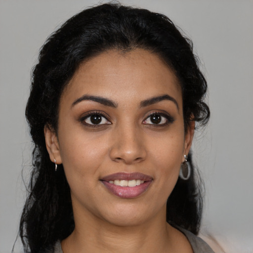 Joyful latino young-adult female with medium  black hair and brown eyes