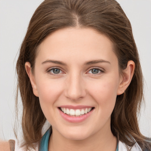 Joyful white young-adult female with long  brown hair and grey eyes