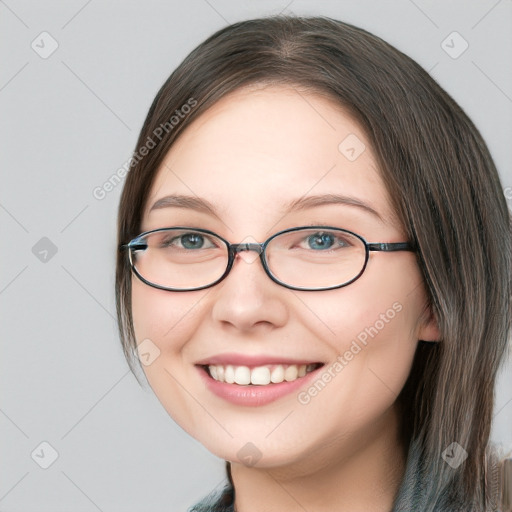 Joyful white young-adult female with medium  brown hair and green eyes