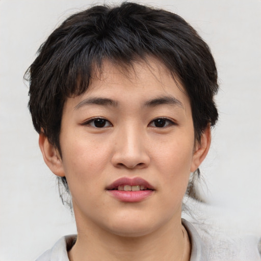 Joyful asian young-adult female with short  brown hair and brown eyes