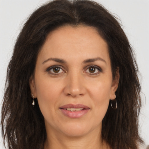 Joyful white adult female with long  brown hair and brown eyes