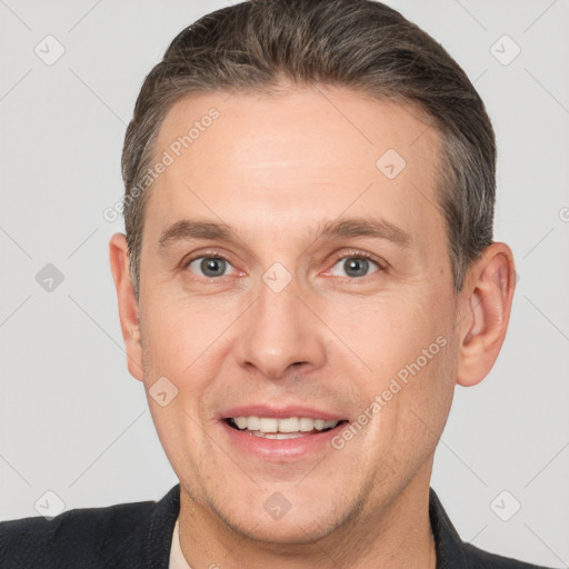 Joyful white adult male with short  brown hair and brown eyes