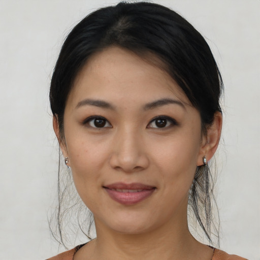 Joyful asian young-adult female with short  brown hair and brown eyes