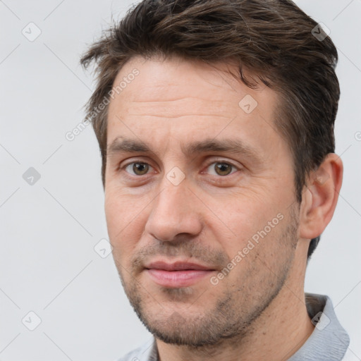 Joyful white adult male with short  brown hair and brown eyes