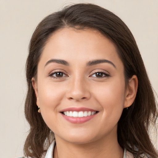 Joyful white young-adult female with long  brown hair and brown eyes