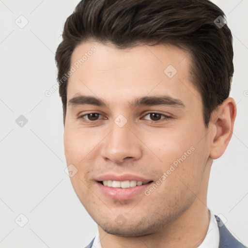 Joyful white young-adult male with short  brown hair and brown eyes