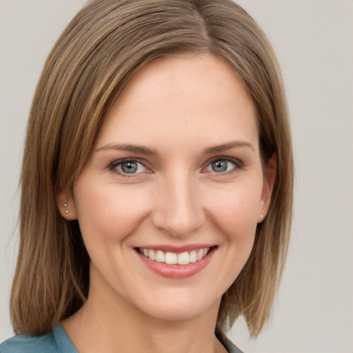 Joyful white young-adult female with medium  brown hair and grey eyes