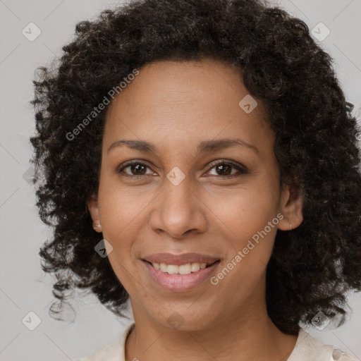 Joyful black adult female with medium  brown hair and brown eyes