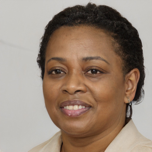Joyful black adult female with short  brown hair and brown eyes