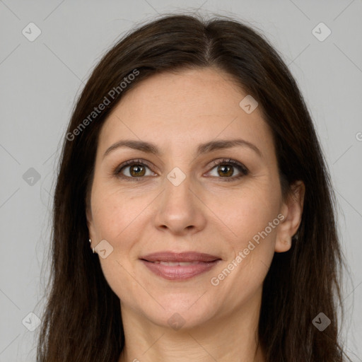 Joyful white adult female with long  brown hair and brown eyes