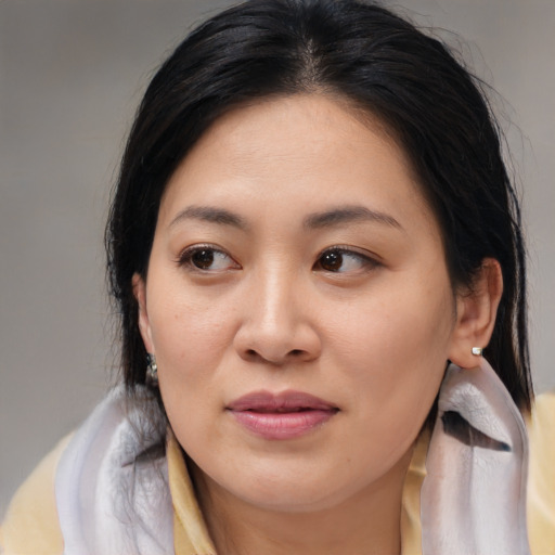 Joyful asian young-adult female with medium  brown hair and brown eyes