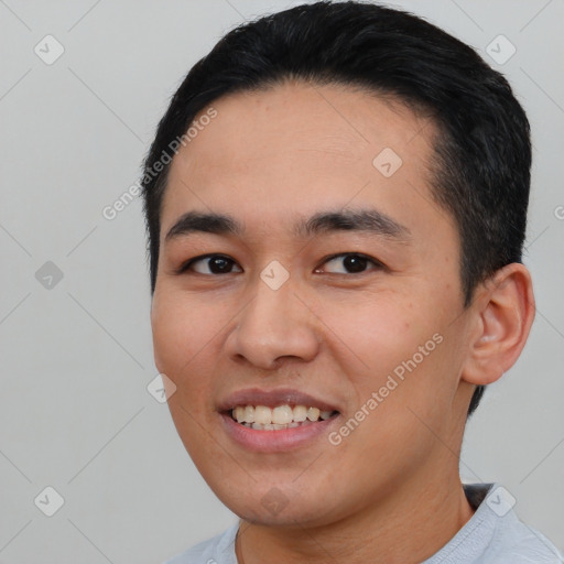 Joyful asian young-adult male with short  black hair and brown eyes